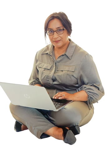 A woman sitting on the ground with her laptop.