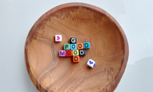 The word good food good mood is written on a plastic cube